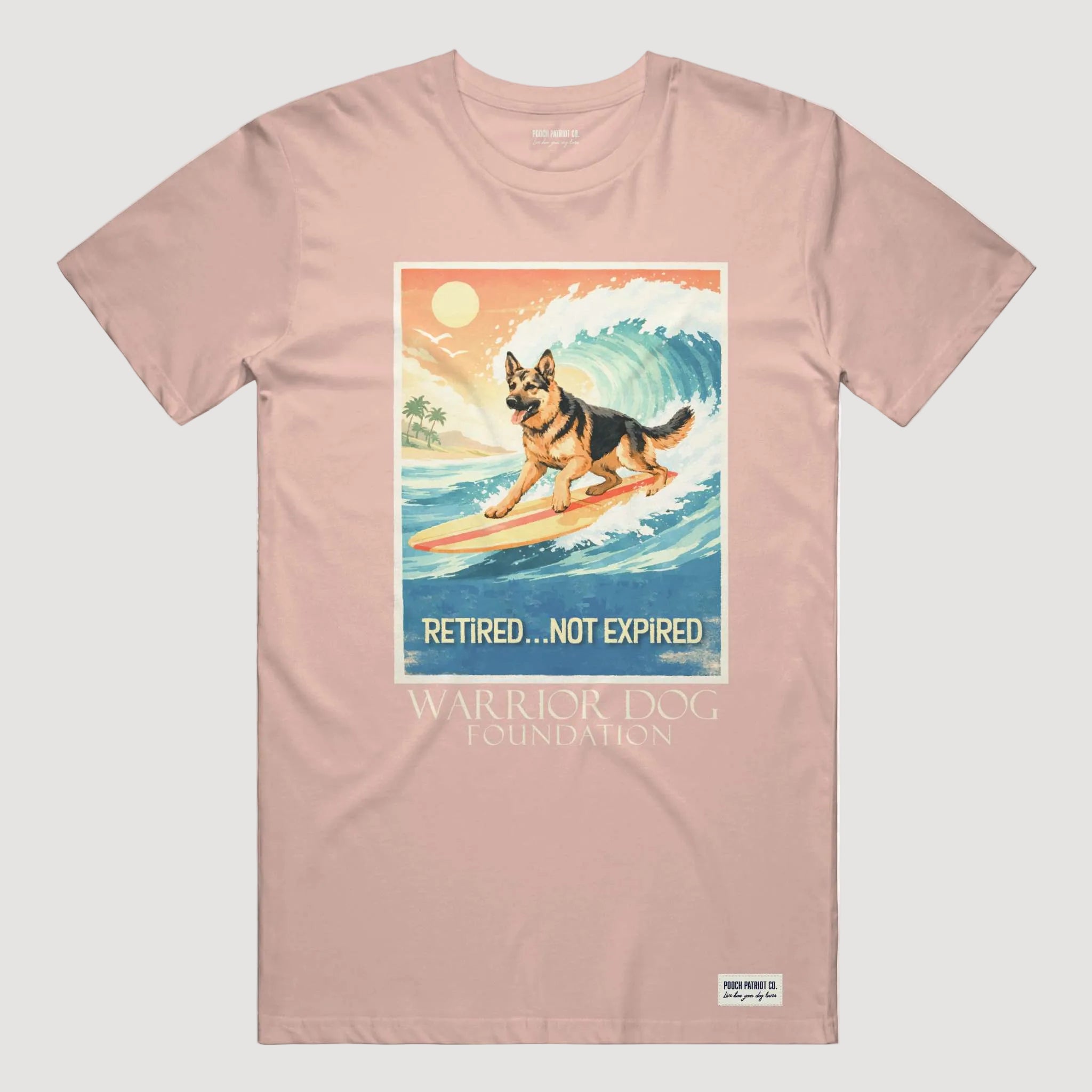 Pink t-shirt with a graphic of a dog on a surfboard and text 'Retired... Not Expired' by Warrior Dog Foundation.