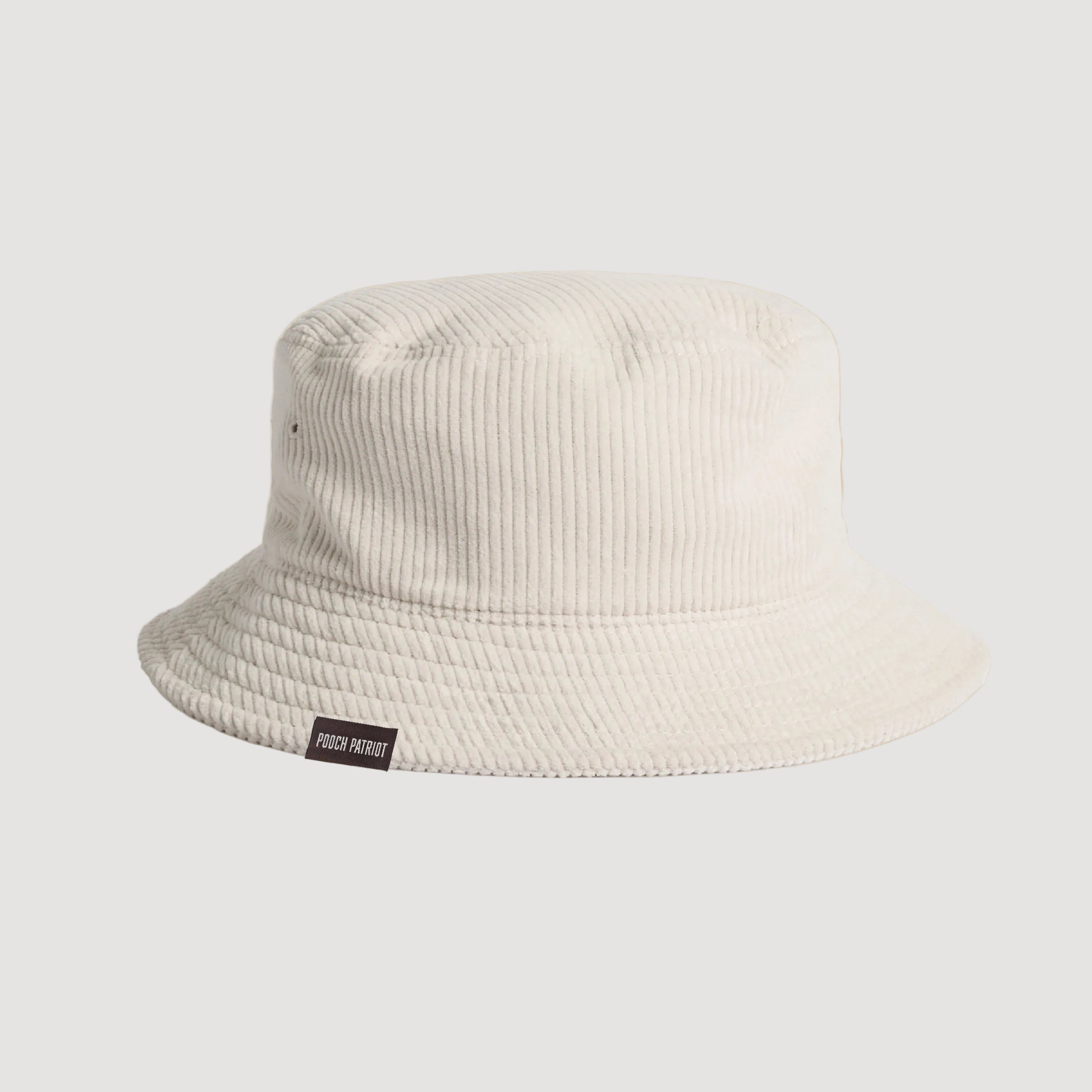 Beige bucket hat with a brand label on a beige background
