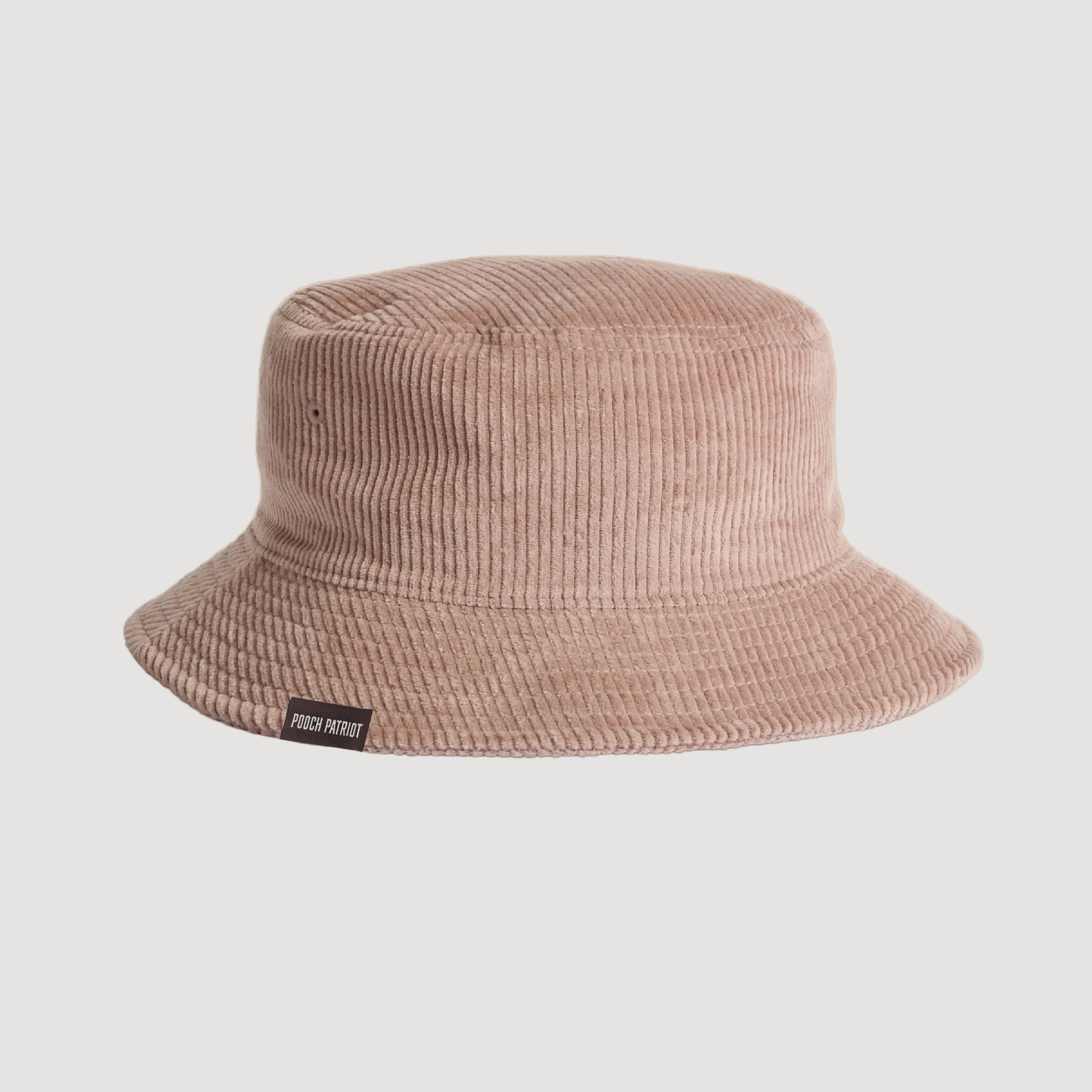Beige bucket hat with a brand label on a beige background