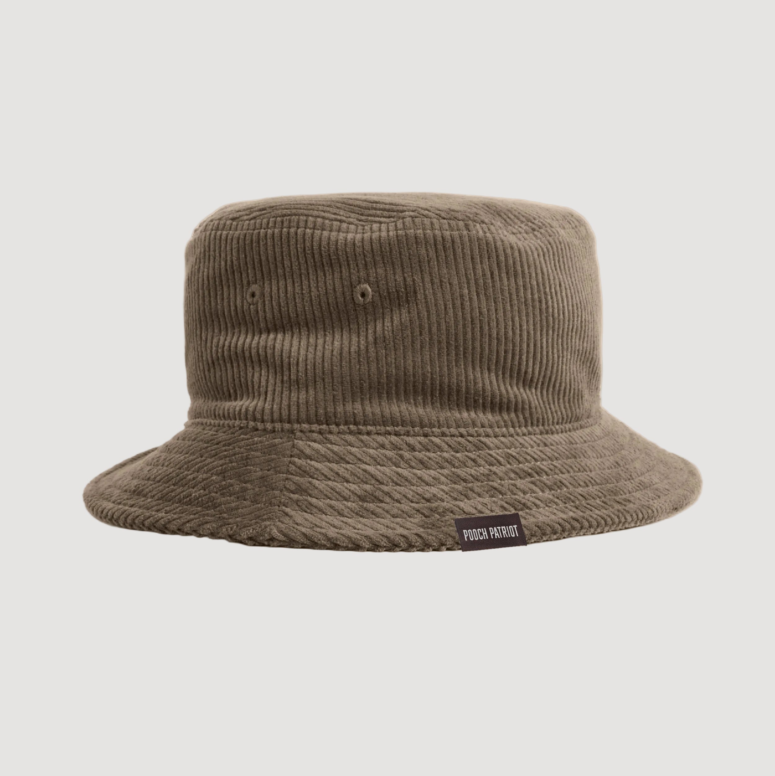 Brown bucket hat with a visible brand label on a beige background