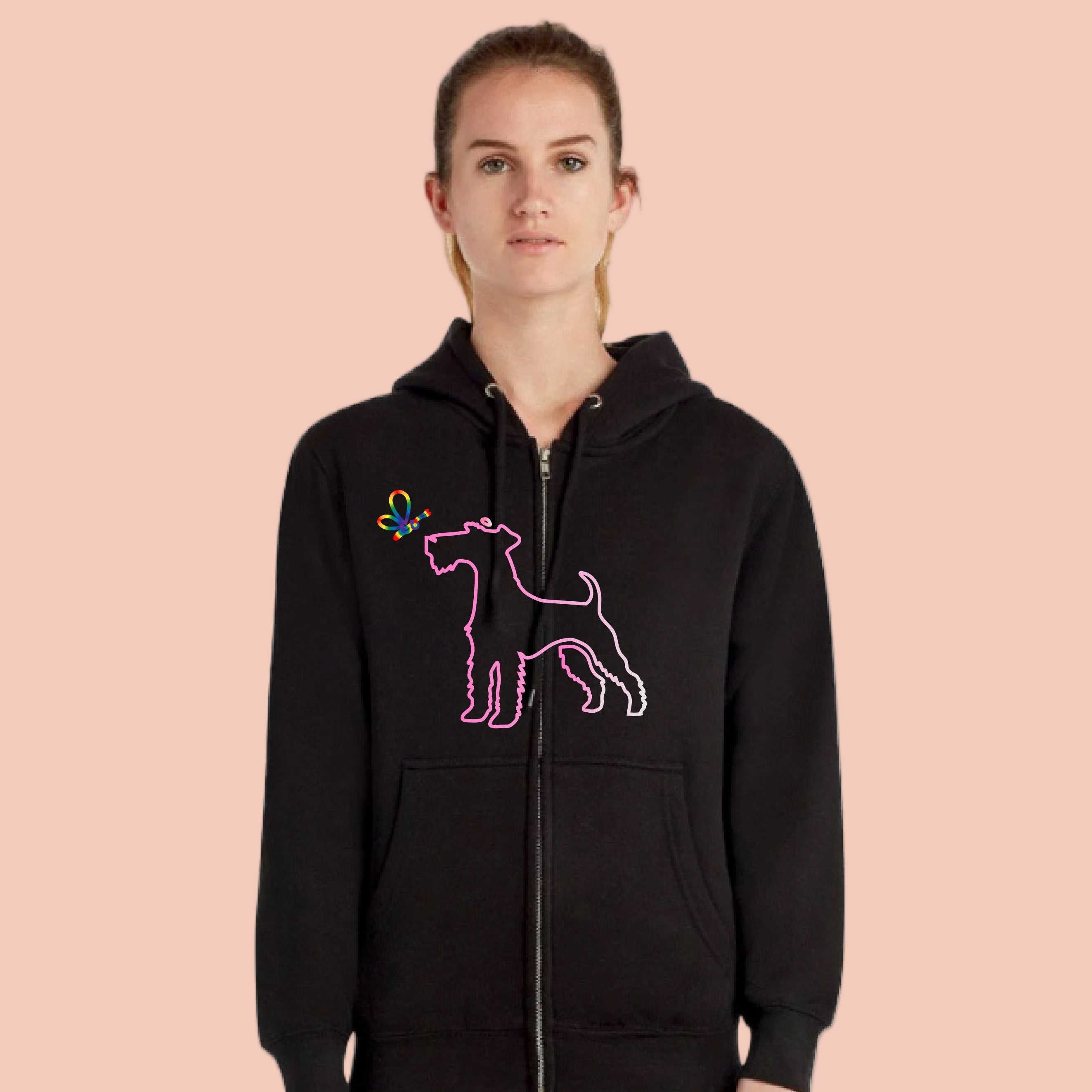 Person wearing a black hoodie with a pink dog design on a pink background