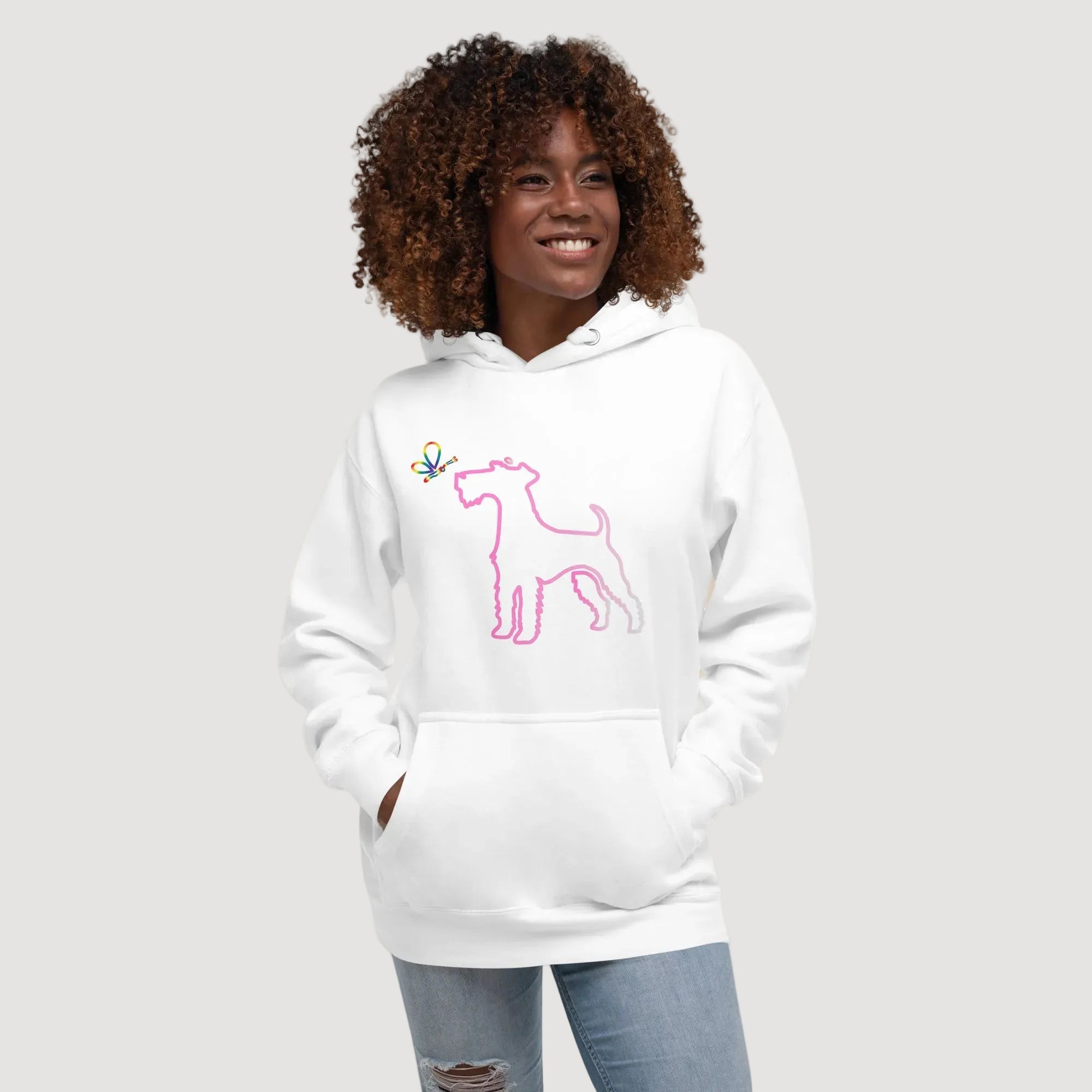 Person wearing a white hoodie with a pink dog design on a beige background