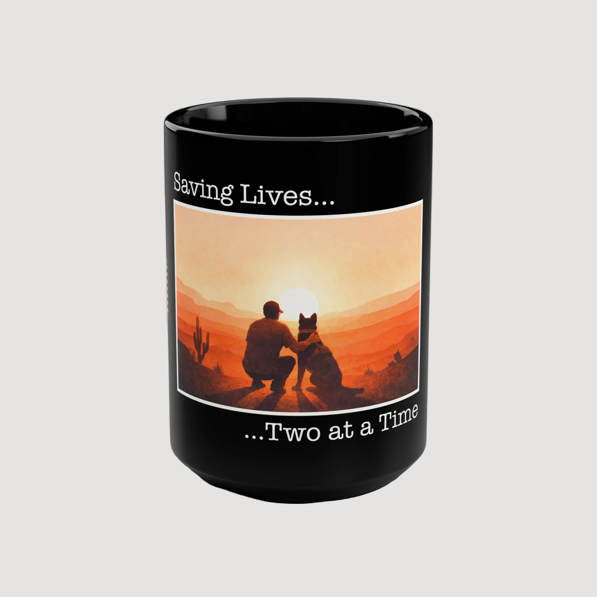 Black mug with a sunset design featuring a person and dog, and text 'Saving Lives... Two at a Time' on a beige background.