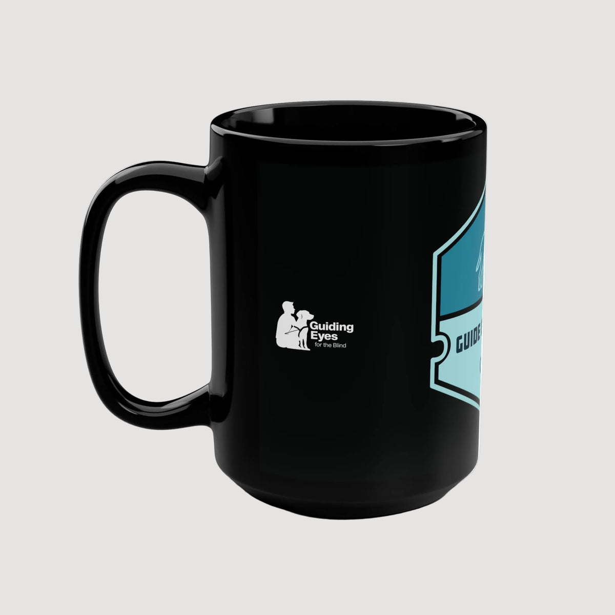 Black mug with Guiding Eyes for the Blind logo on a white background