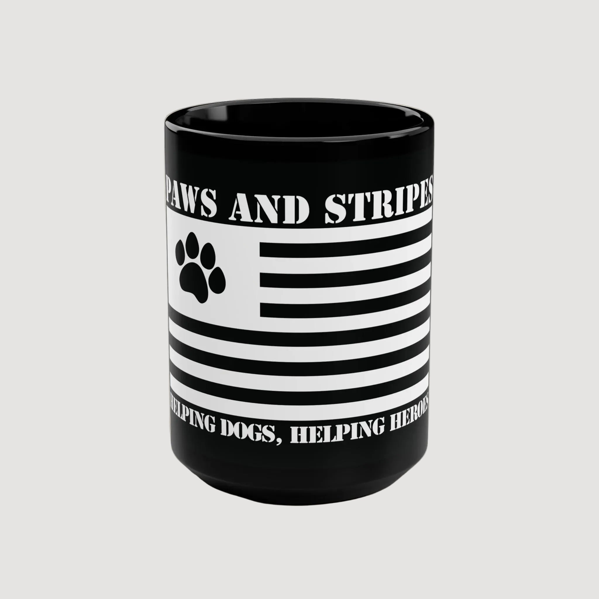 Black mug with American flag design and text 'Paws and Stripes: Helping Dogs, Helping Heroes' on a white background