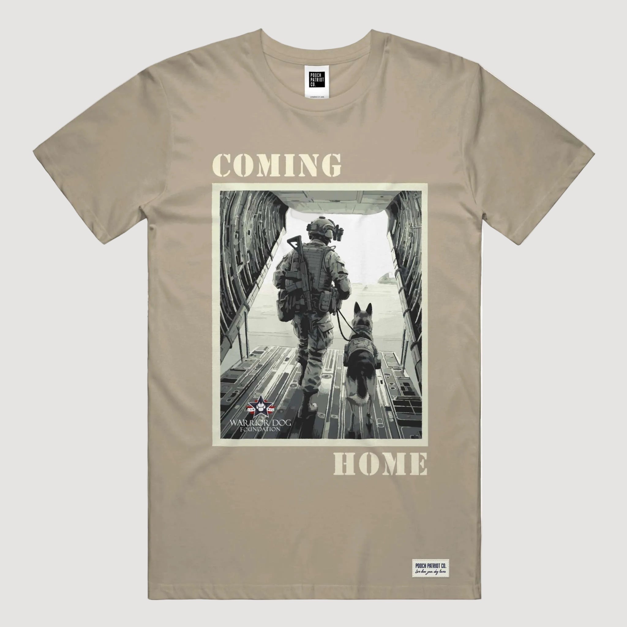 Beige t-shirt with a graphic of a soldier and dog walking through an aircraft, with 'COMING HOME' text.