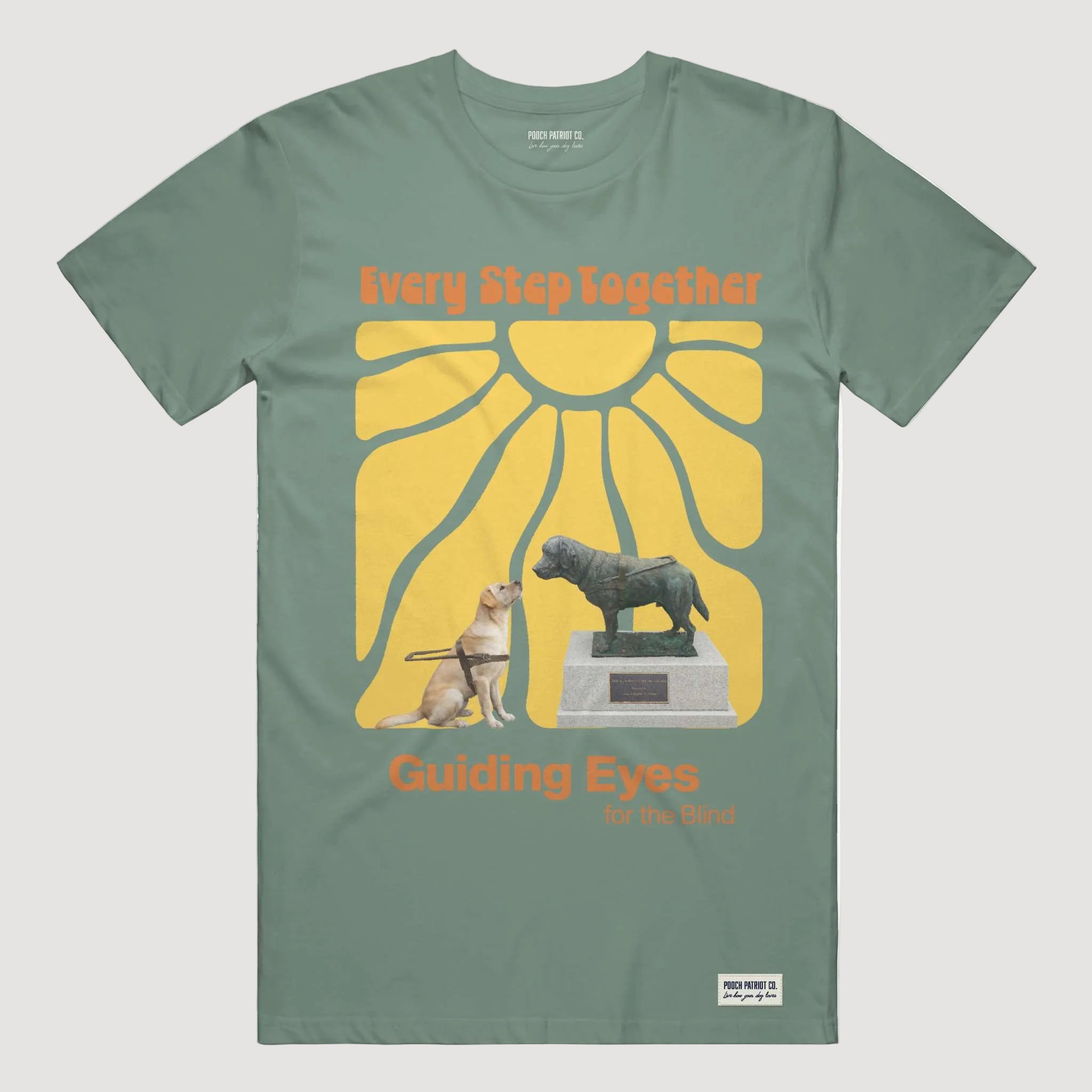 Green t-shirt with 'Guiding Eyes for the Blind' graphic featuring a dog and statue.