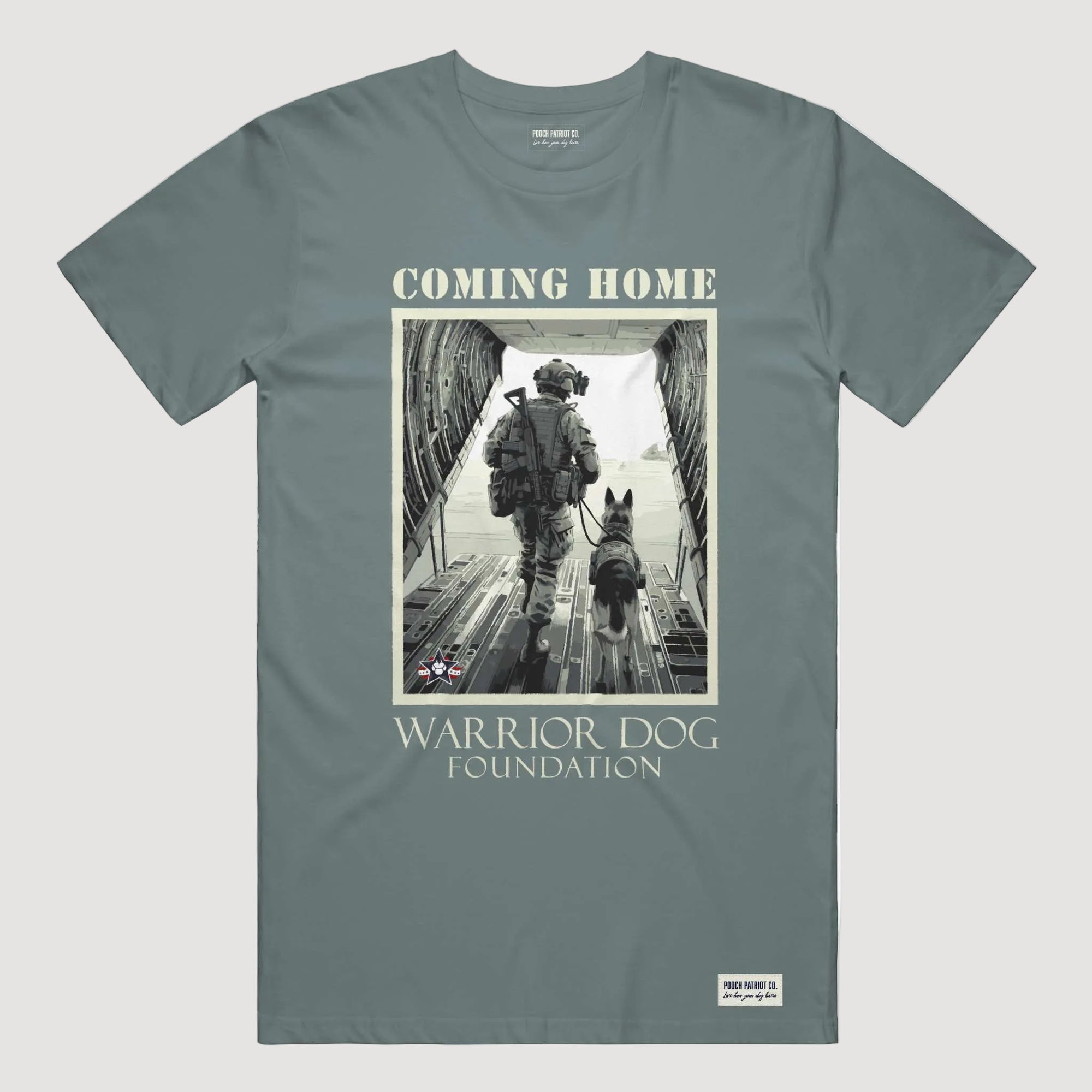 T-shirt with a graphic of a soldier and dog walking towards an airplane, labeled 'Coming Home Warrior Dog Foundation'.