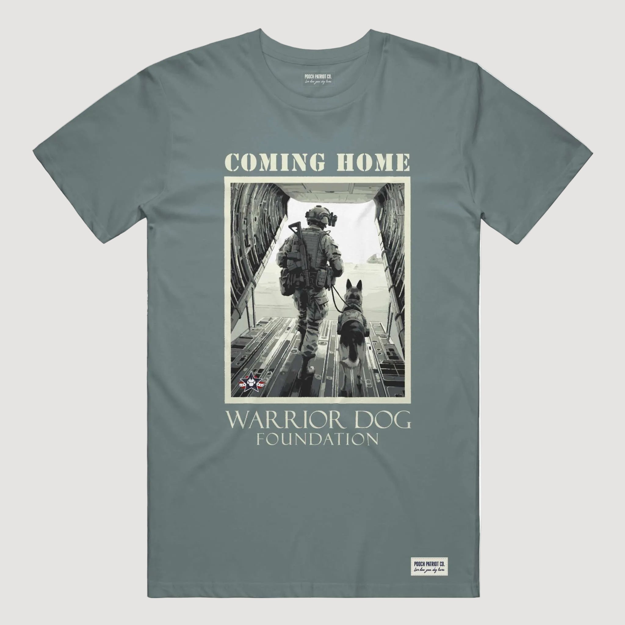 T-shirt with a graphic of a soldier and dog walking towards an airplane, labeled 'Coming Home Warrior Dog Foundation'.