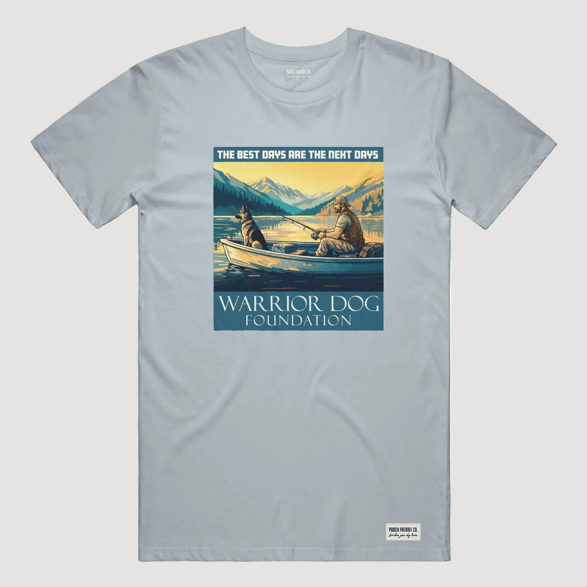 Gray t-shirt with a graphic of two people in a boat and mountains, featuring 'Warrior Dog Foundation' text.