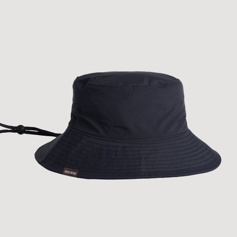 Black bucket hat on a beige background