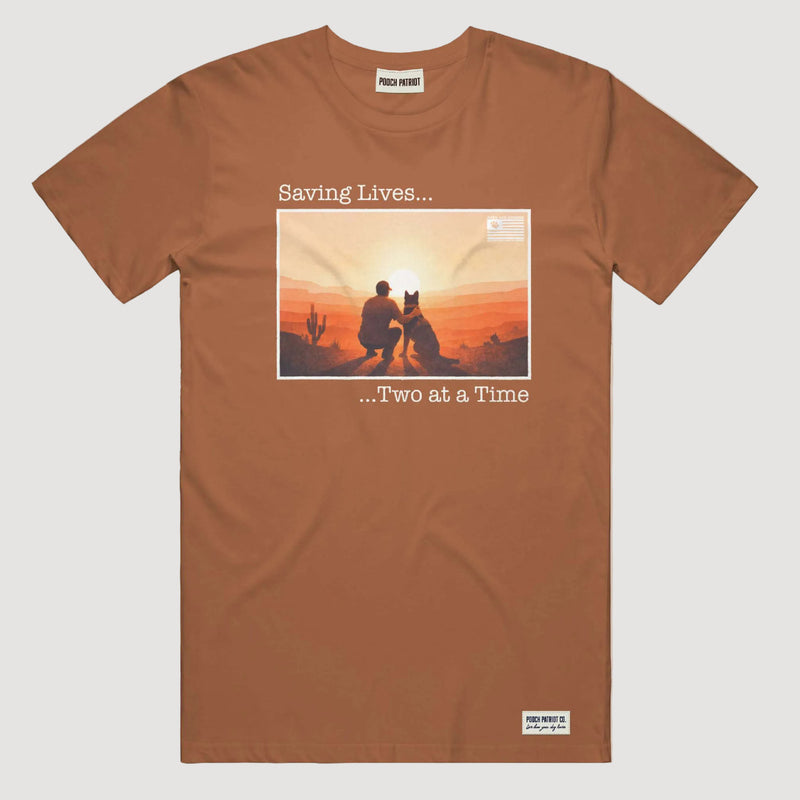 Brown t-shirt with graphic of a man and dog sitting together at sunset, text 'Saving Lives.