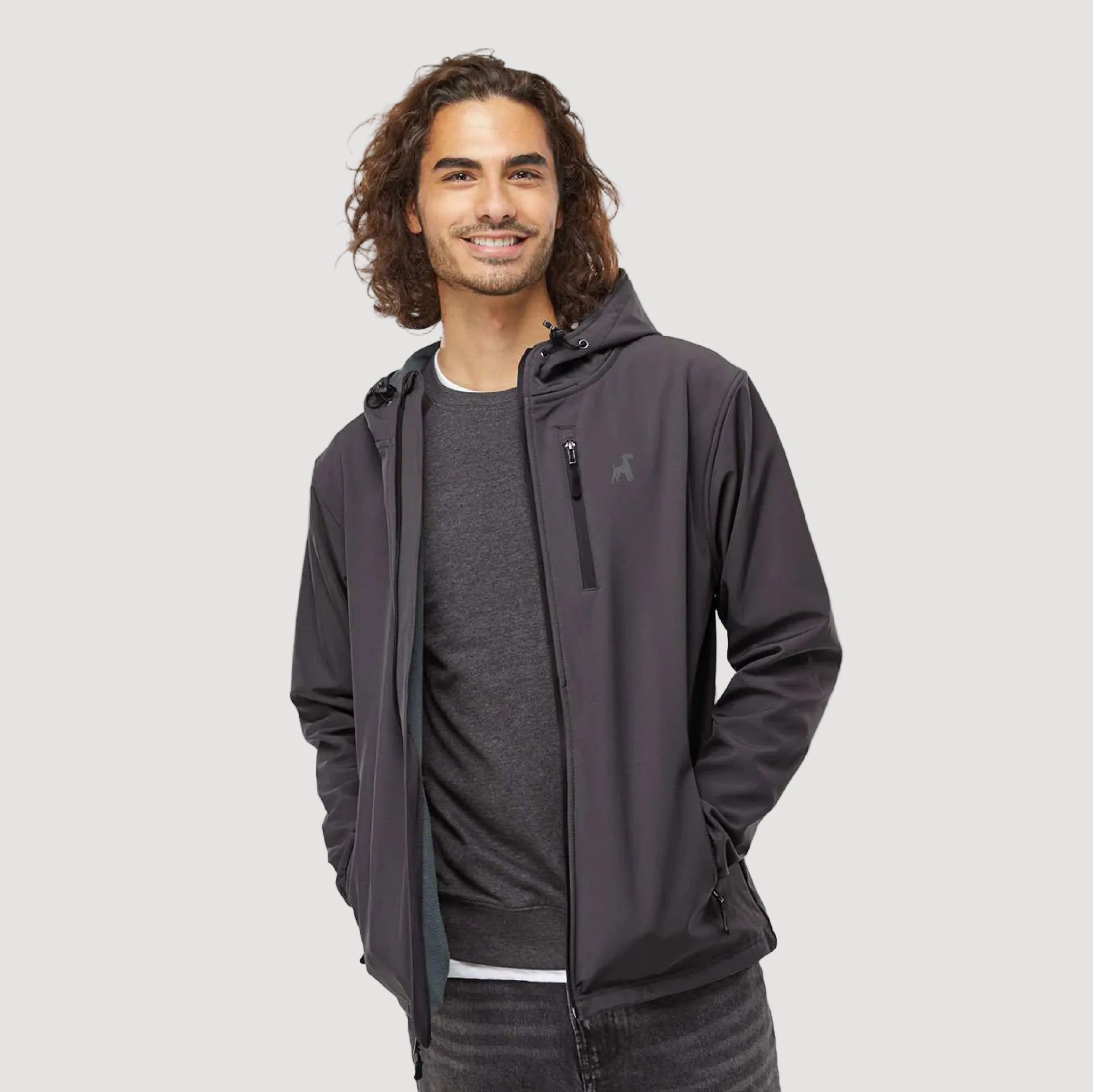 Man wearing a dark gray jacket on a beige background