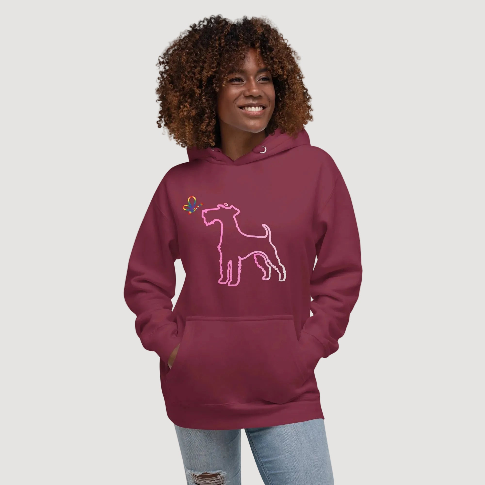 Woman wearing a maroon hoodie with a dog design on a beige background