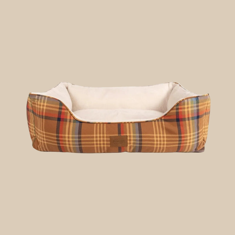 Plaid patterned pet bed with beige interior on a white background