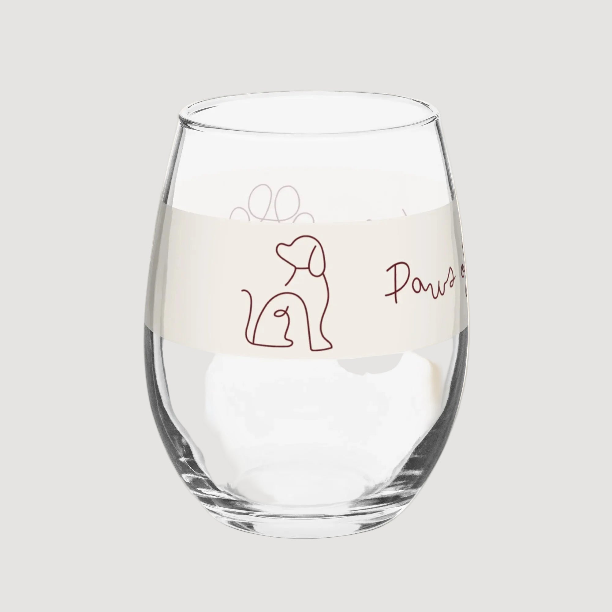 Clear glass with dog illustration and 'Paws' text on a beige background